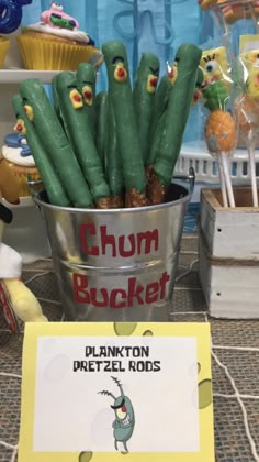 a bucket filled with lots of green plants next to a sign that says chum bucket