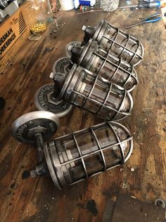 several metal objects sitting on top of a wooden table