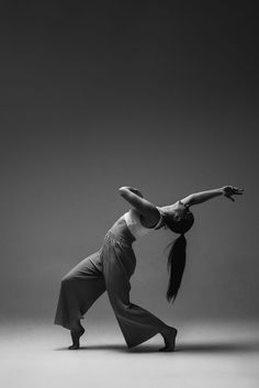 a woman is doing an acrobatic dance pose