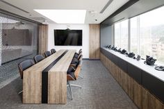 an empty conference room with chairs and a flat screen tv mounted on the wall above it