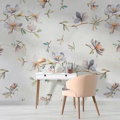 the wallpaper is painted with flowers and leaves on it, along with a chair