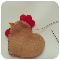 a felt heart with a chicken on it