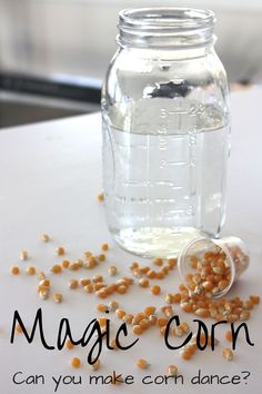 a jar filled with corn sitting on top of a table