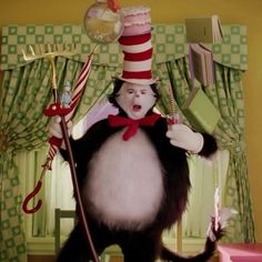 the cat in the hat is holding a wand