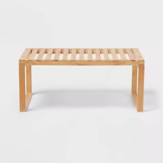 a wooden bench sitting on top of a white floor