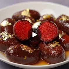 a white plate topped with chocolate covered donuts