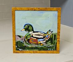 a painting of a duck sitting on top of a counter