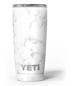 the yeti cup is white and has a marble pattern on it's side