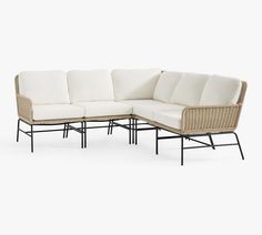 an outdoor sectional sofa with white cushions and black metal frame, on a white background