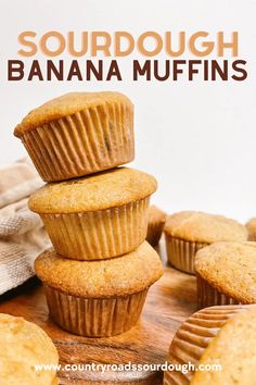 a stack of banana muffins sitting on top of a wooden cutting board