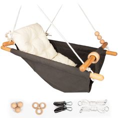 a toy swing with wooden handles and strings attached to the seat, along with other toys