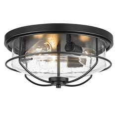 an outdoor flush light fixture with clear glass and black metal trim, on a white background