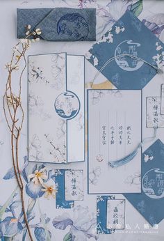 an assortment of blue and white paper with flowers on it