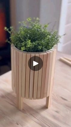 a wooden planter sitting on top of a table next to a wood burning stove