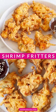 shrimp fritters on a white plate with dipping sauce and sprinkled sesame seeds