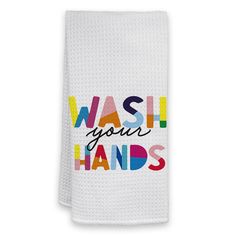 a white hand towel with the words wash your hands on it in multicolored letters