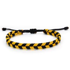 a yellow and black rope bracelet on a white background