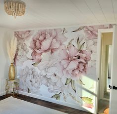 a large floral wall mural in a bedroom