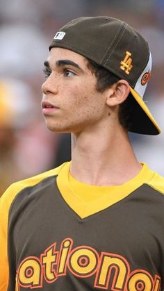 a baseball player wearing a brown and yellow uniform