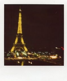 the eiffel tower is lit up at night