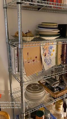 a metal shelf filled with dishes and plates