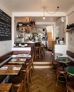 an empty restaurant with wooden tables and chairs