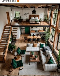 an aerial view of a living room with green accents and white couches in the center