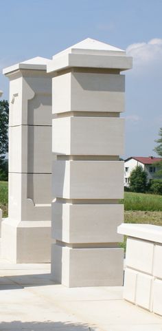 a large white sculpture sitting on top of a cement slab