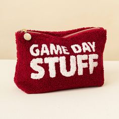 a red purse with the words game day stuff on it