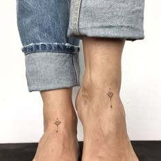 two people with matching tattoos on their feet, one is wearing blue jeans and the other has