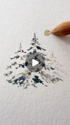 a pencil drawing a snowflake with watercolors on paper and an ink brush