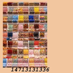 there is a large display of many different types of candies in plastic containers on the wall