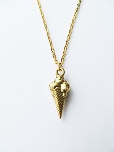 Fun three scoop ice cream cone necklace. This necklace is made of gold plated steel chain (45cm approx) with detailed Ice Cream gold pewter charm (20 x 8mm). It will arrive in an organza bag ready for gift giving. If you have any questions regarding shipping and payment, please take a look at my shop policies: http://www.etsy.com/uk/shop/LadyMangoJewellery/policy?ref=shopinfo_policies_leftnav ● Shipping: For customers in the UK your order shall arrive within a week though in most cases it's much faster, get in touch if your order is time sensitive and I will do my best to help.  For customers outside the UK, your order can take 1-4 weeks so please leave plenty of time, 80% of orders arrive within 2 weeks.  During Christmas time, please check on our shop announcement for cut-off dates. Ice Cream Necklace, Ice Cream Jewelry, Cream Necklace, Scoop Ice Cream, Holiday Vacation, Ice Cream Cone, Cream And Gold, Summer Jewelry, Organza Bags