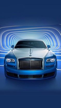 the front end of a blue and white rolls royce parked in an abstract background with lines