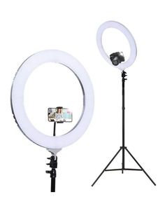 the ring light is set up on a tripod and stands next to an iphone