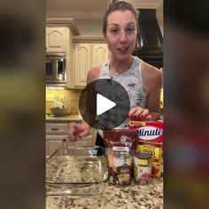 a woman standing in front of a kitchen counter with ingredients on the counter and an empty bowl next to her