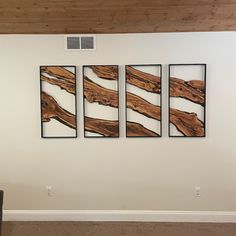 three pieces of wood are hanging on the wall