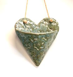 a ceramic heart hanging on a rope