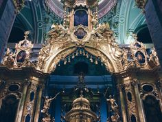 an ornate gold alter in a church with blue walls