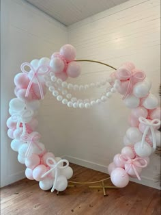 a balloon arch with pink and white balloons