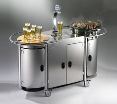 a bar cart with beer glasses and food on the top, in front of it