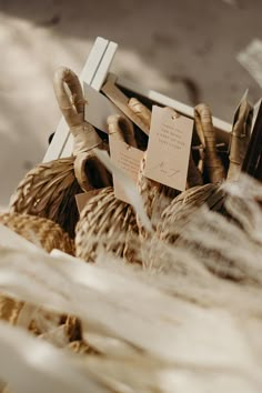 a basket filled with lots of stuff sitting on top of a floor next to a pile of feathers