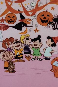 a group of children standing in front of halloween decorations