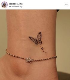 a small ankle tattoo with a butterfly on the top and stars on the bottom side