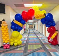 balloons and streamers decorate the hallway of an office building