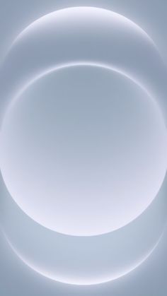 an abstract white circular background with some light in the middle and no one around it