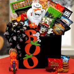 a halloween gift basket filled with candy, candies and stuffed animals on a table