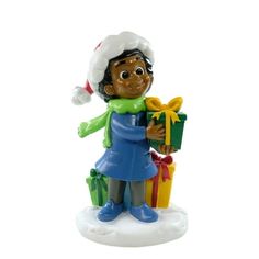 a christmas ornament with a boy holding presents in his hands and wearing a santa hat