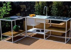 an outdoor kitchen with sink and counter top