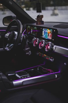 the interior of a car with various gauges and dash lights, including an iphone